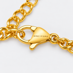 Greyford Assisi Cross Chain Bracelet — close-up of the piece and brand engraving