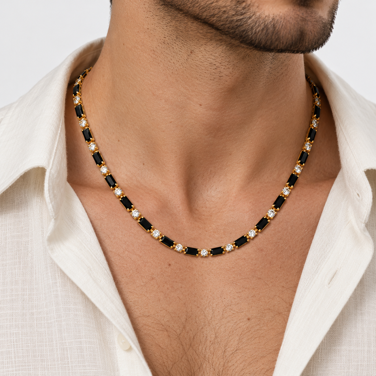 Greyford Capri Black and Gold Station Necklace — worn by a model, close-up studio photograph