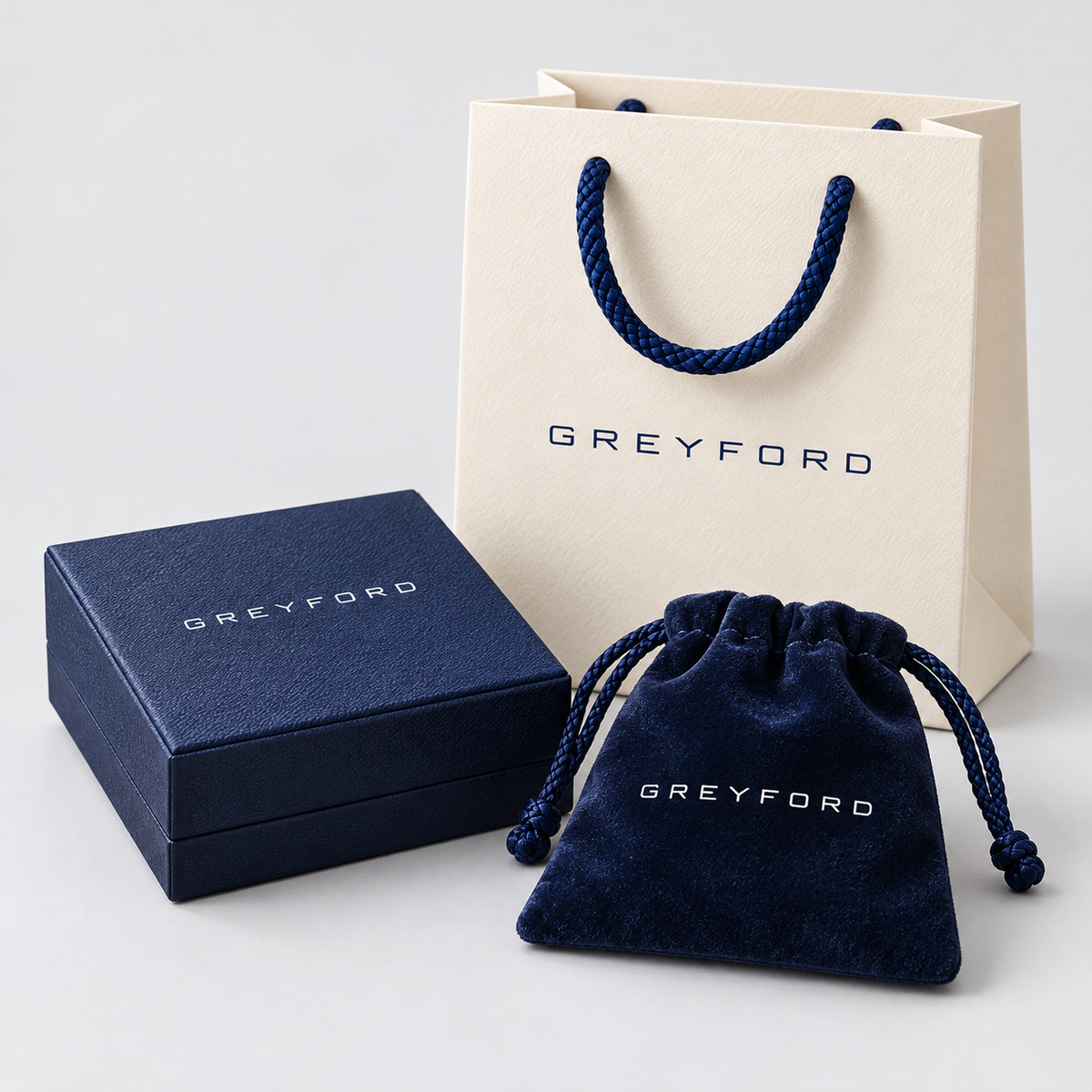 Greyford branded jewelry box, pouch and gift bag on a light gray studio background